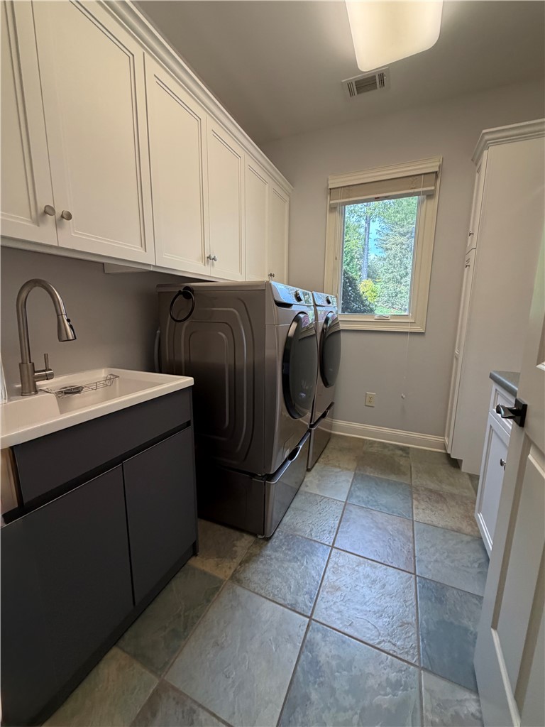 357 Stardust Lane Seneca, SC 29672 - Photo 28 of 50 Laundry Room - A function workspace is provided by abundant cabinetry and durable tile flooring.