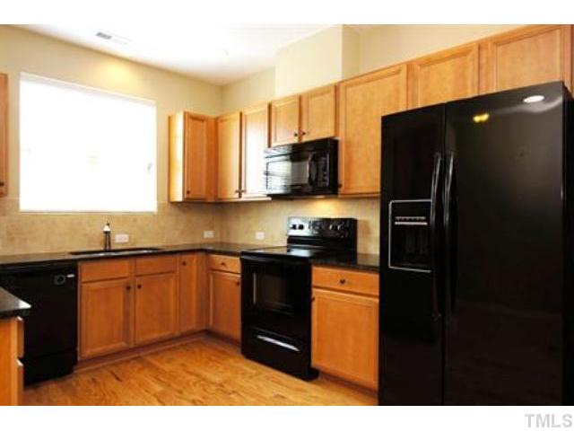 748 Wickham Ridge Road, Unit 115 Apex, NC 27539 - Photo 4 of 25 Granite countertops, tile backsplash, and upgraded cabinets! (Photo of like design. Colors/selections may vary - ask onsite agent for details.)