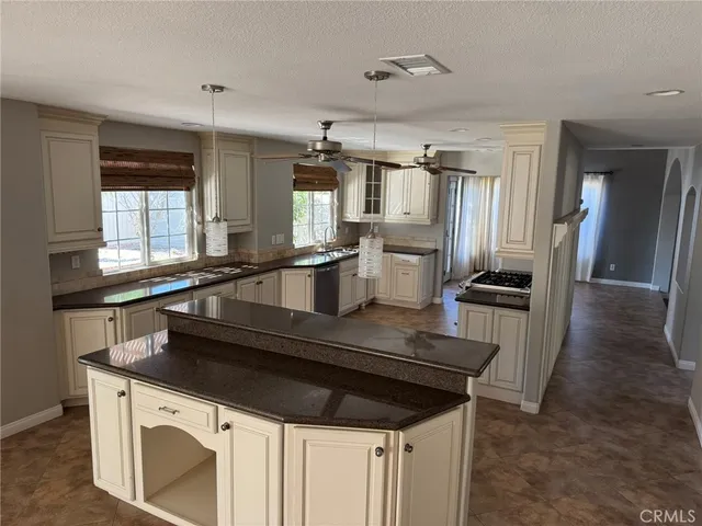 a kitchen with a sink appliances and cabinets