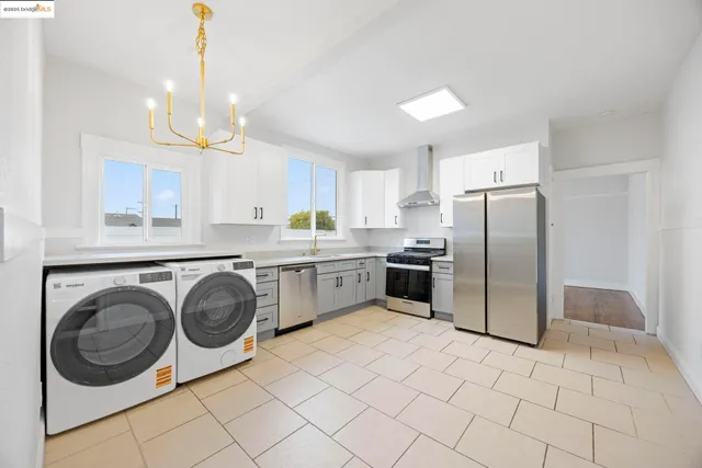 a kitchen with a sink a refrigerator and cabinets
