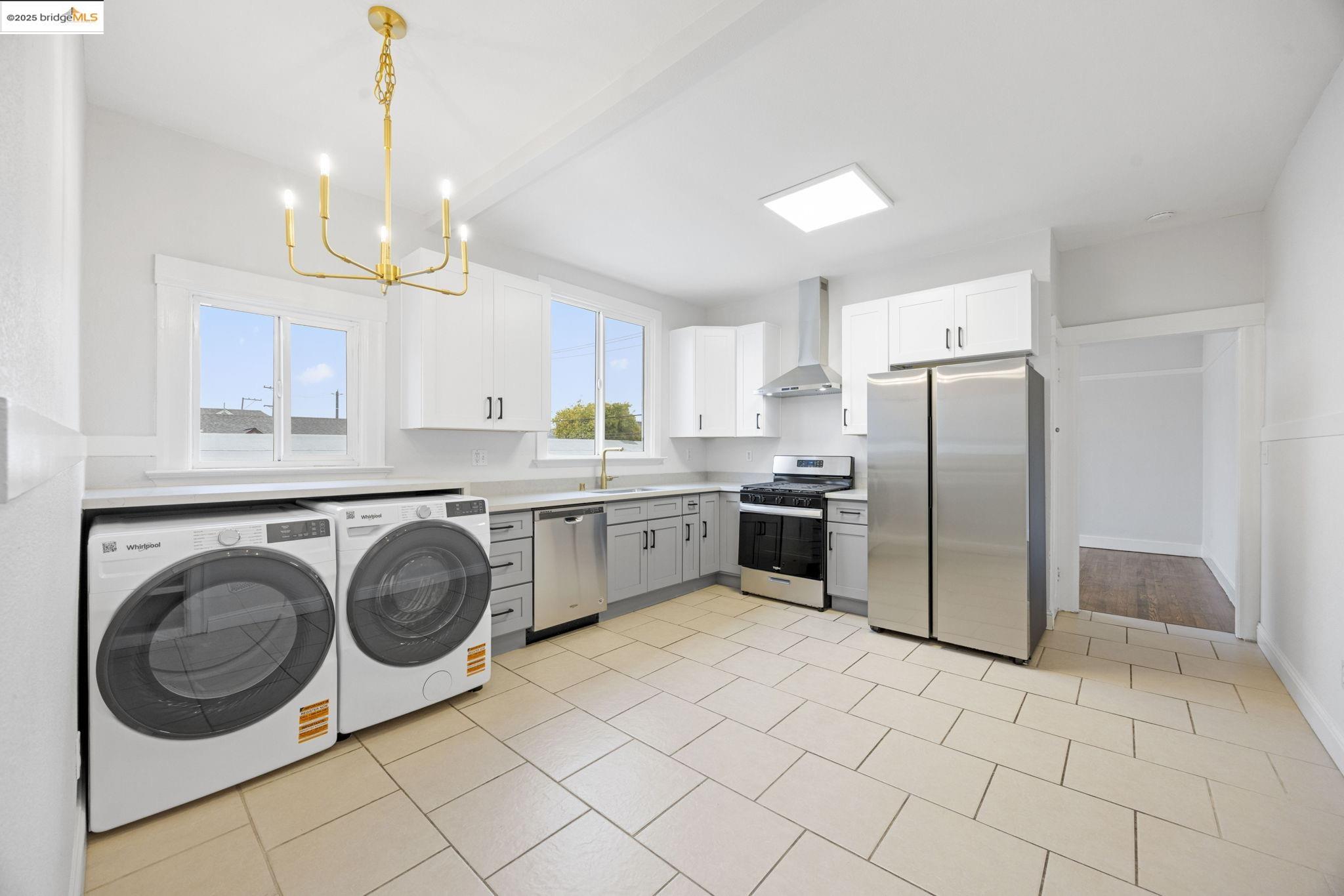 a kitchen with a sink a refrigerator and cabinets