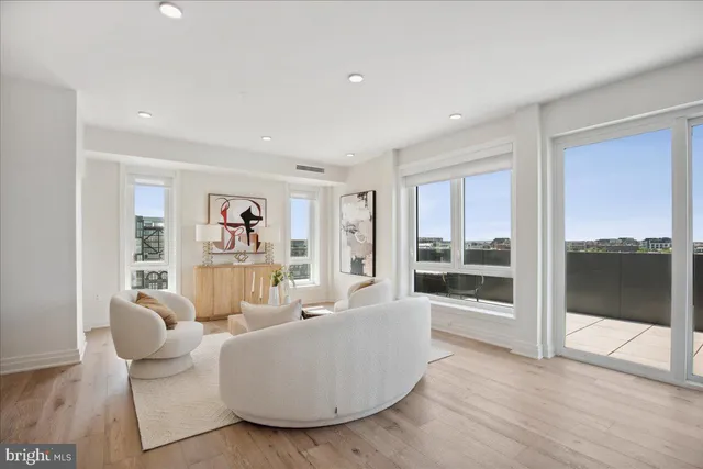 a living room with furniture and a floor to ceiling window