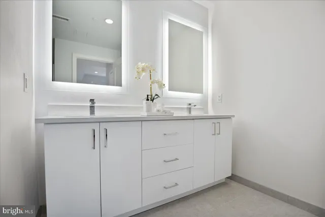 a bathroom with a shower and a glass door