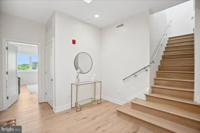 a view of entryway and hall with wooden floor