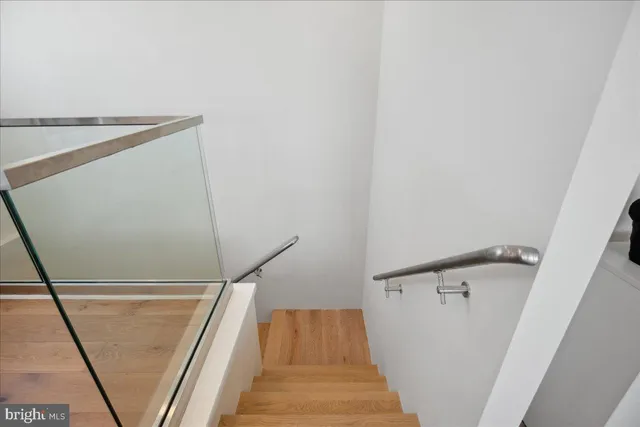 a kitchen with stainless steel appliances a stove a sink a cabinets and a dining table