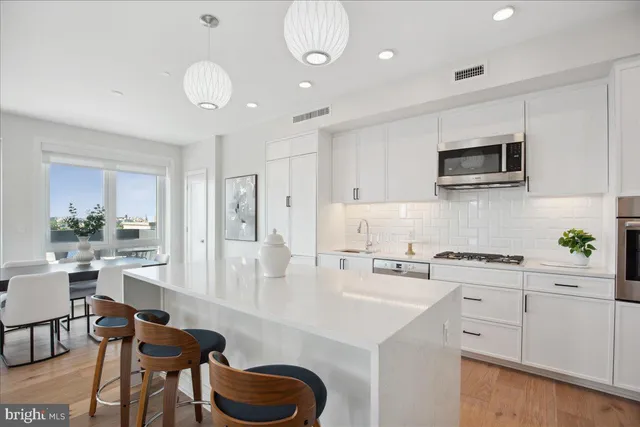 a kitchen with a sink and a white cabinets