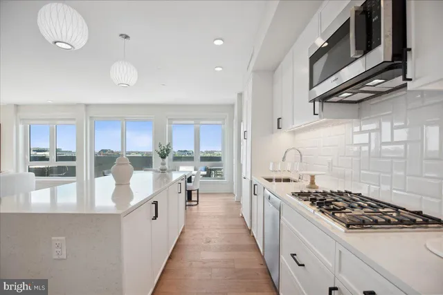 a white stove top oven sitting inside of a kitchen