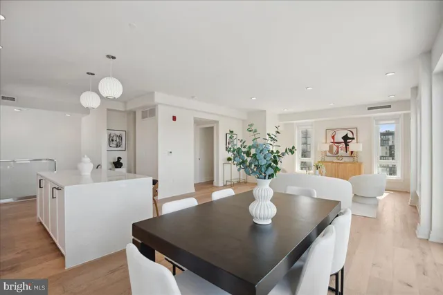 a view of a hallway with wooden floor and windows