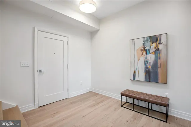 a view of entryway and hall with wooden floor
