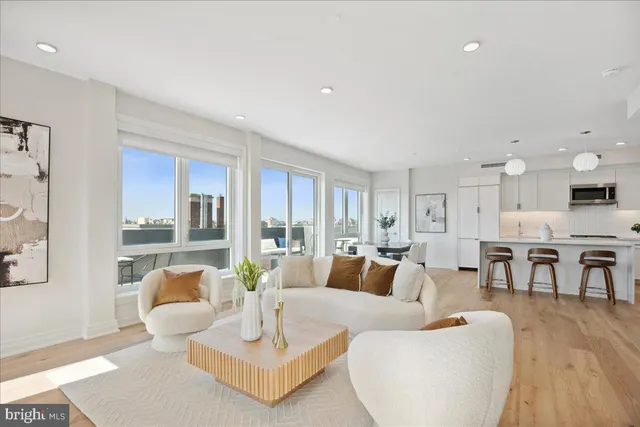 a bathroom with a granite countertop toilet sink and mirror