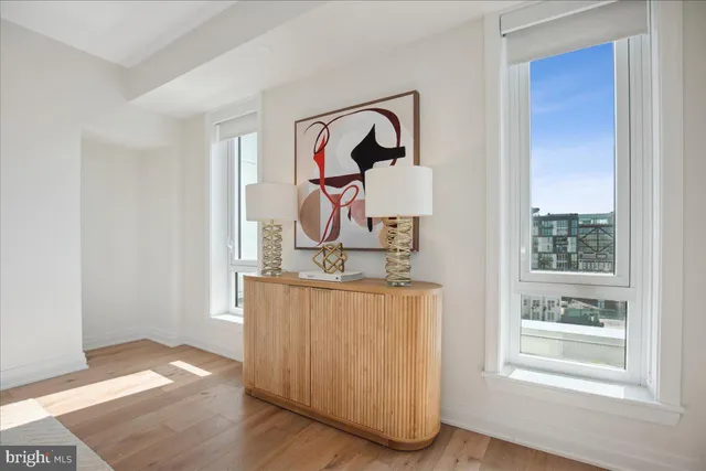 a living room with a couch and a painting on the wall