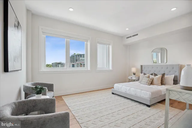 a bedroom with a large bed and a window