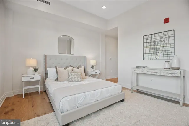 a bedroom with a bed and a table