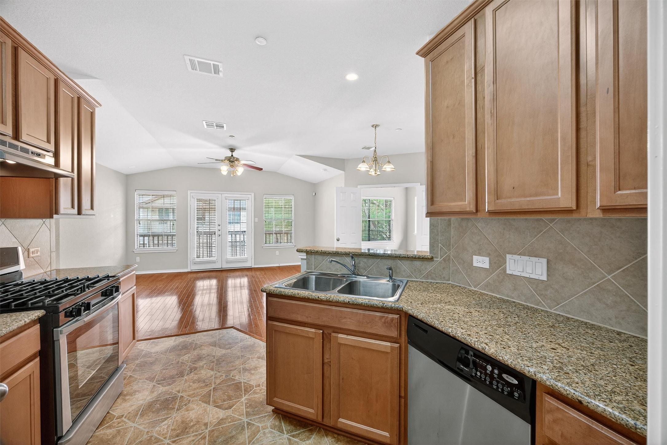 1310 West Parmer Lane, Unit 601 Austin, TX 78727 - Photo 13 of 40 a kitchen with granite countertop a sink stove and cabinets