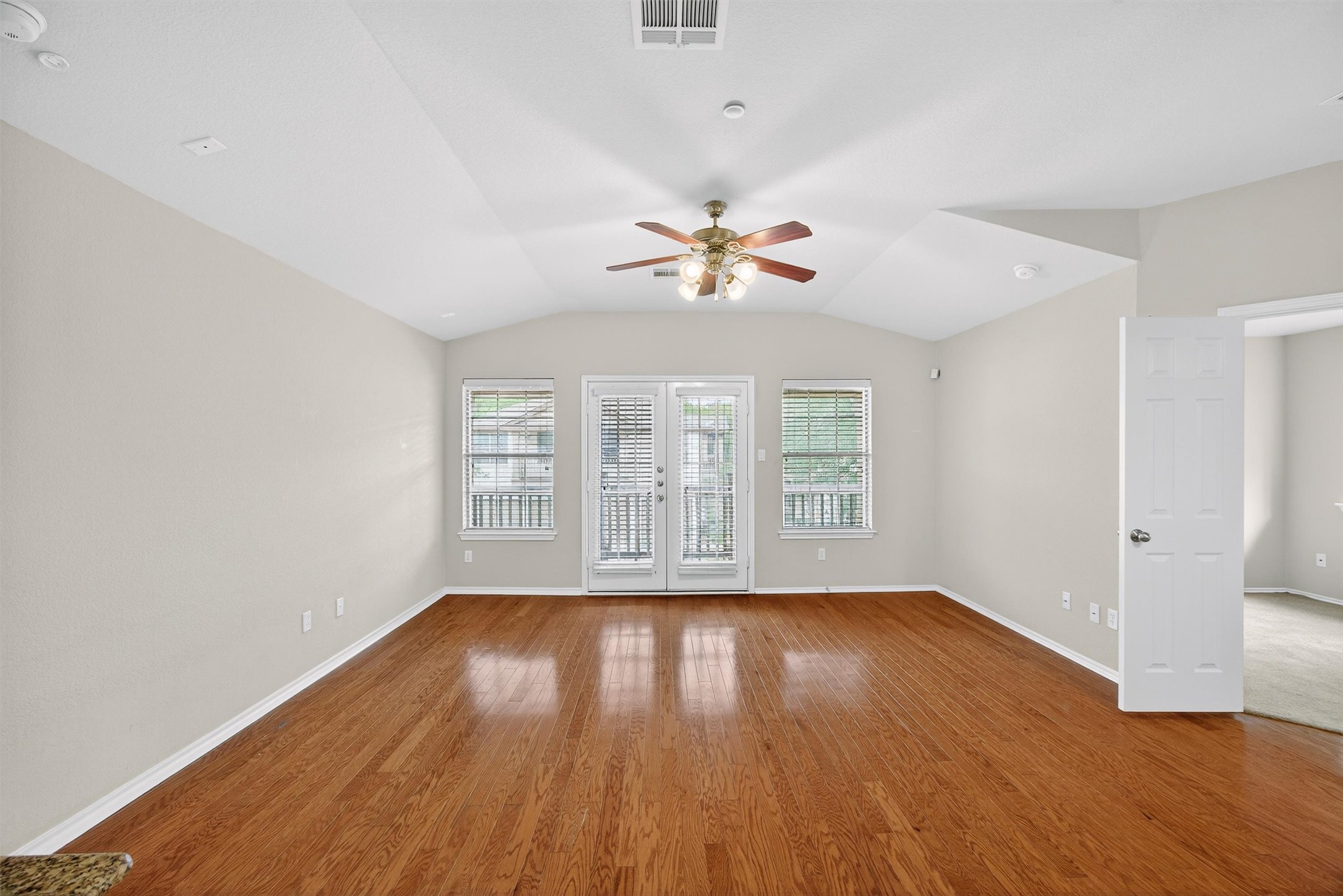 1310 West Parmer Lane, Unit 601 Austin, TX 78727 - Photo 14 of 40 an empty room with wooden floor and windows