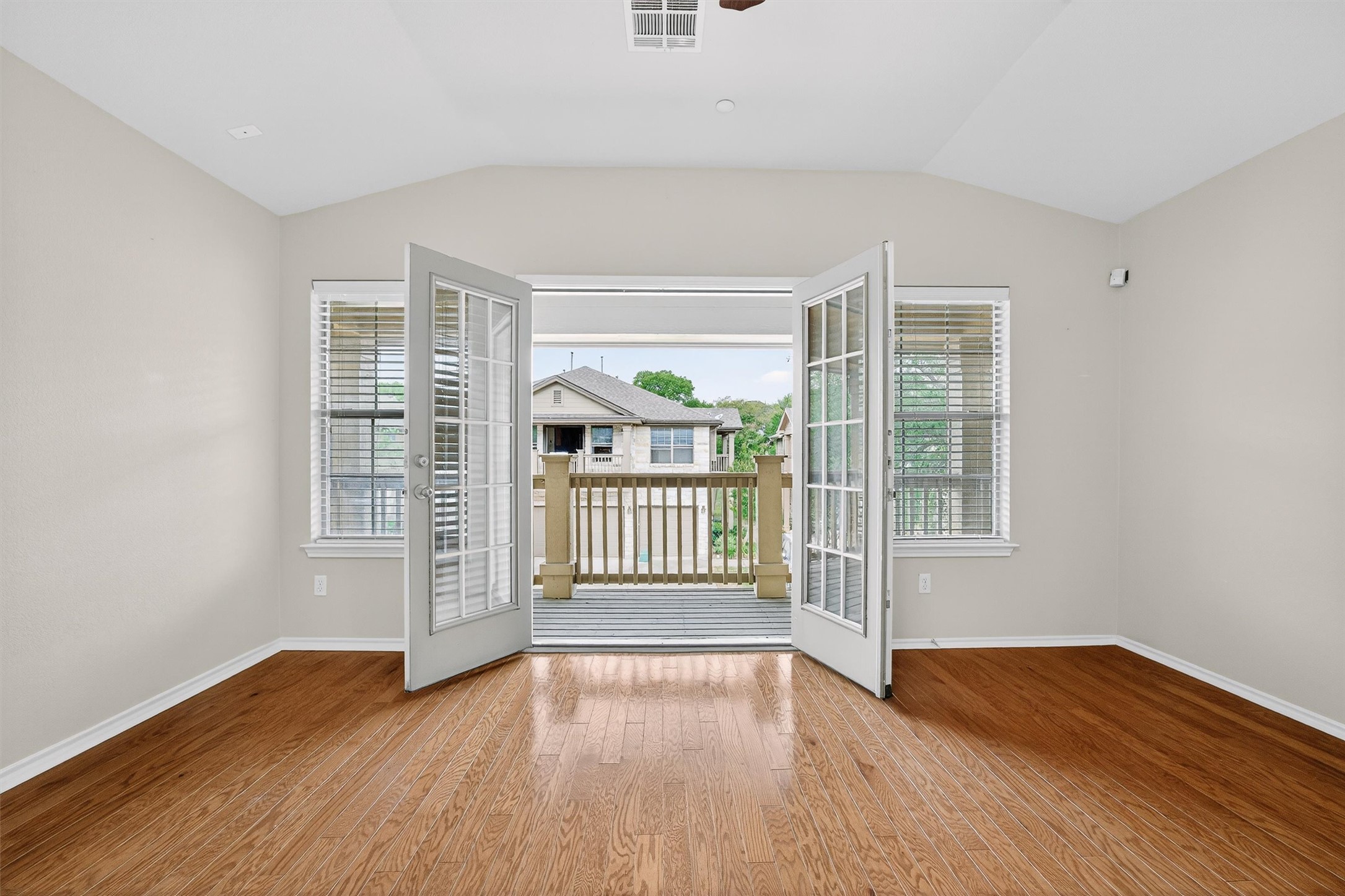 1310 West Parmer Lane, Unit 601 Austin, TX 78727 - Photo 15 of 40 an empty room with wooden floor and windows