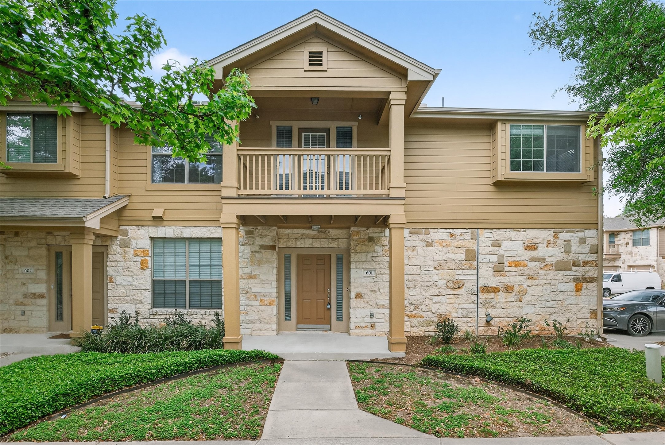 1310 West Parmer Lane, Unit 601 Austin, TX 78727 - Photo 2 of 40 a front view of a house with garden