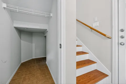 a view of a hallway with wooden floor and entryway