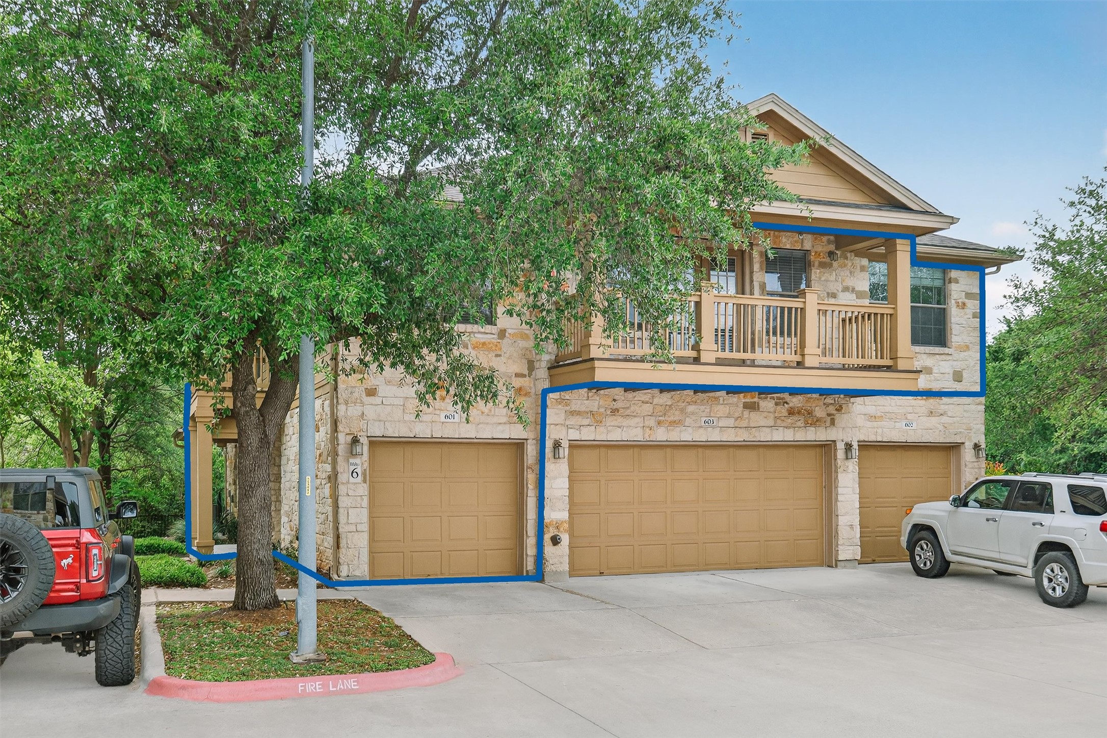 1310 West Parmer Lane, Unit 601 Austin, TX 78727 - Photo 36 of 40 a front view of a house with a yard and garage