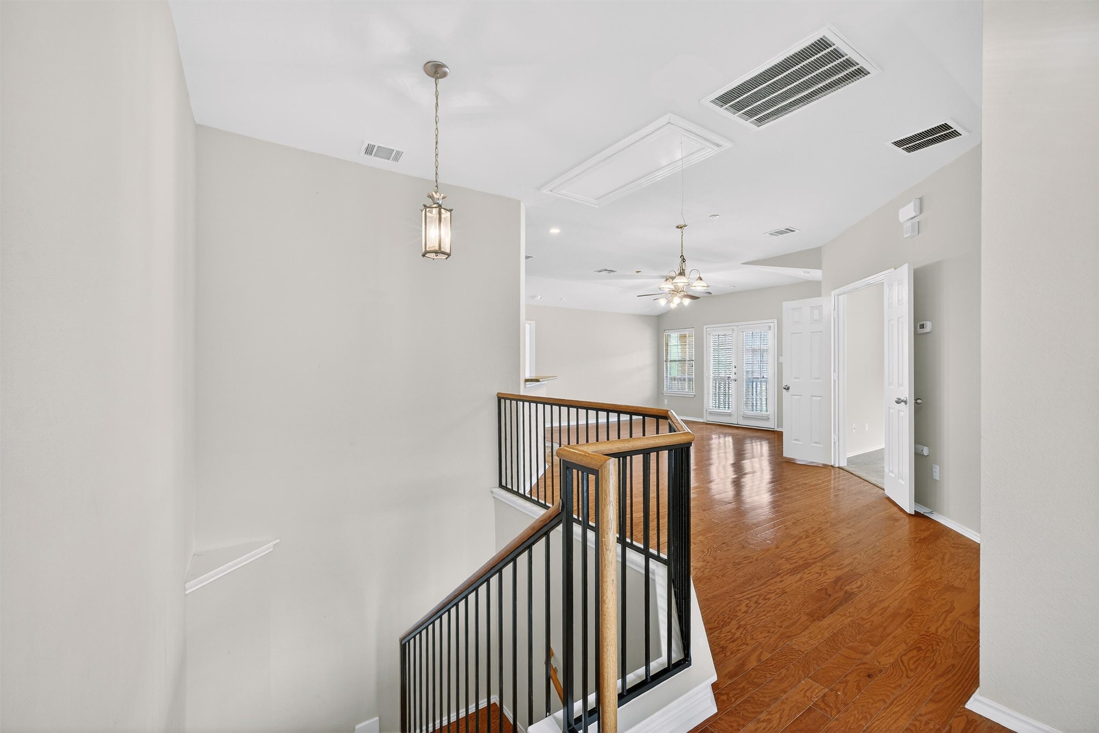 1310 West Parmer Lane, Unit 601 Austin, TX 78727 - Photo 38 of 40 a view of a hallway with wooden floor and chandelier