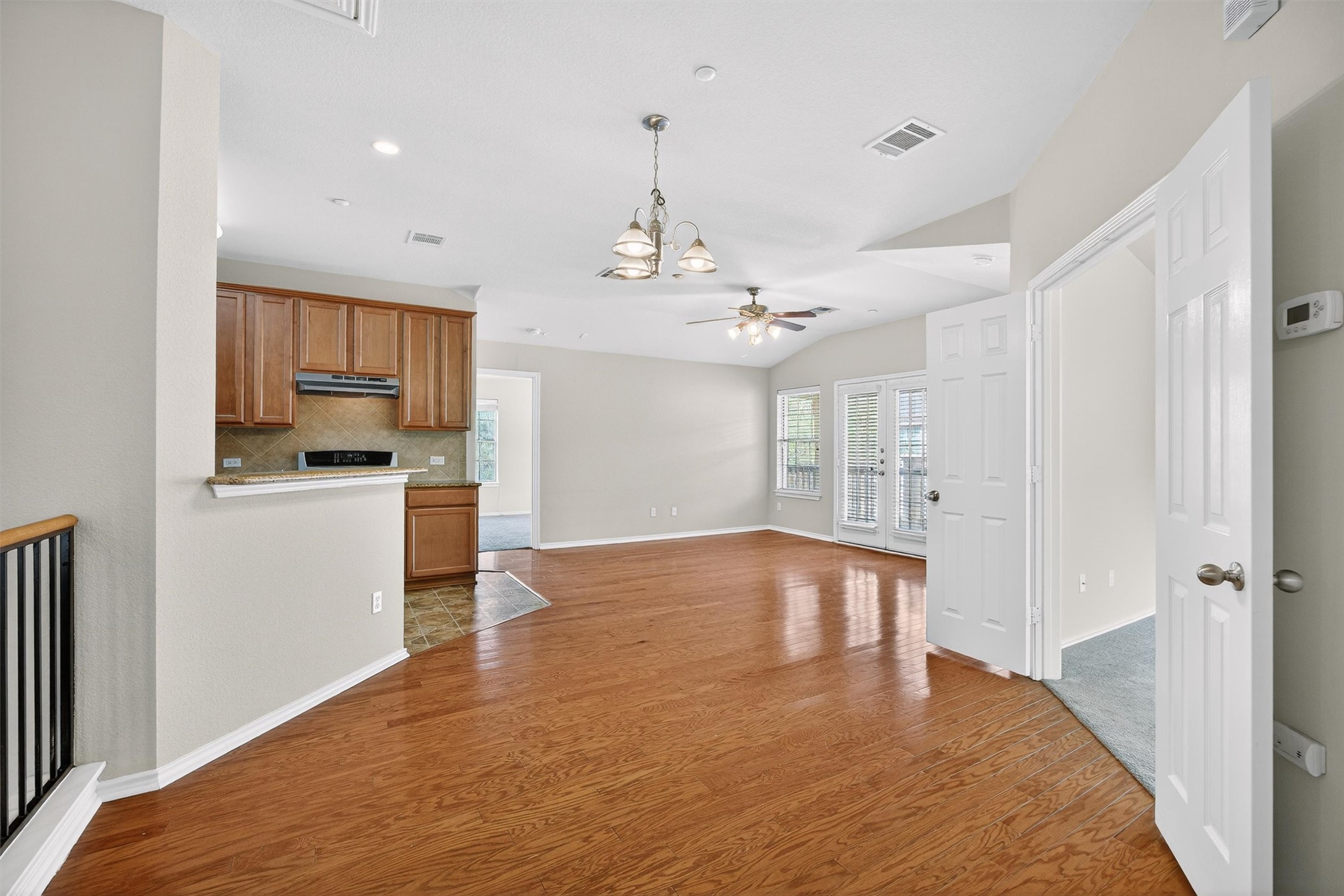 1310 West Parmer Lane, Unit 601 Austin, TX 78727 - Photo 39 of 40 a view of a kitchen with a sink and dishwasher a refrigerator with wooden floor