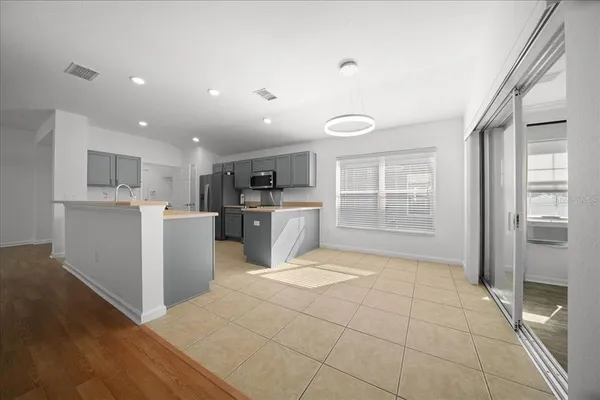 a view of a kitchen with furniture and wooden floor