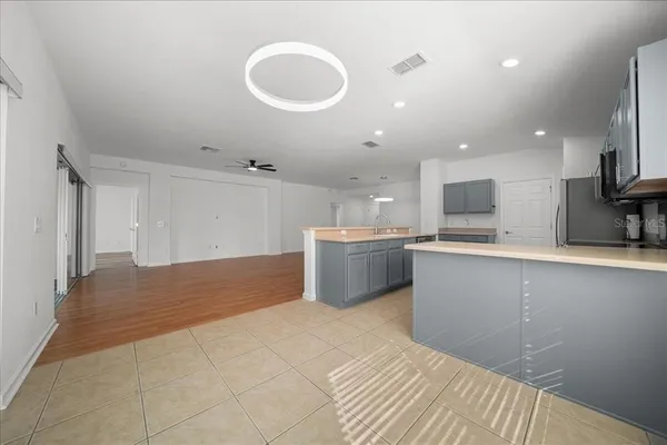 a kitchen with kitchen island sink and cabinets