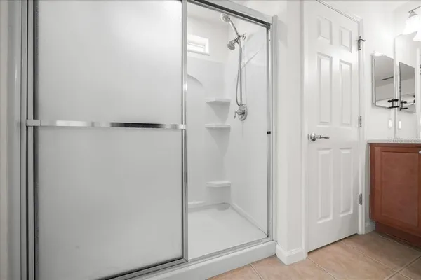 a bathroom with a glass shower door