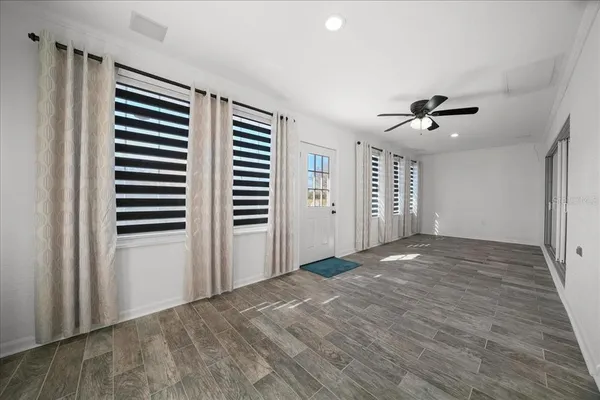 a view of an empty room with a ceiling fan