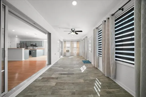a view of a hallway with a dining table chair and a kitchen island