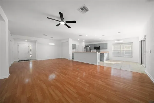 a view of a kitchen with a sink and wooden floor