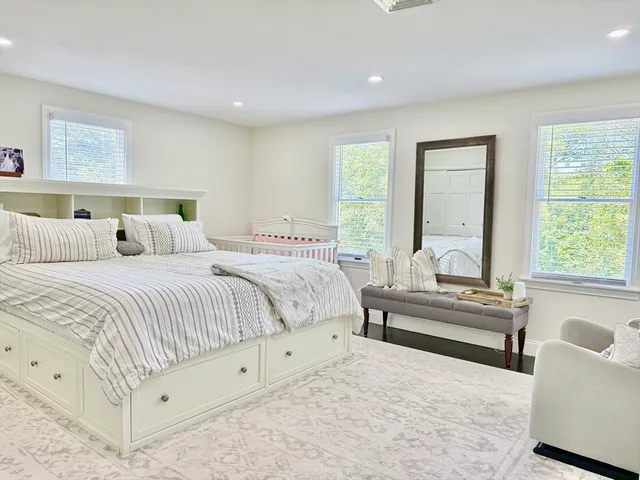 a view of a room with wooden floor and windows