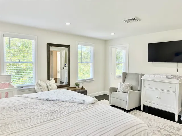 a bathroom with a sink a toilet and a window