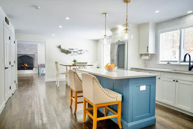 a view of a hallway with wooden floor and furniture