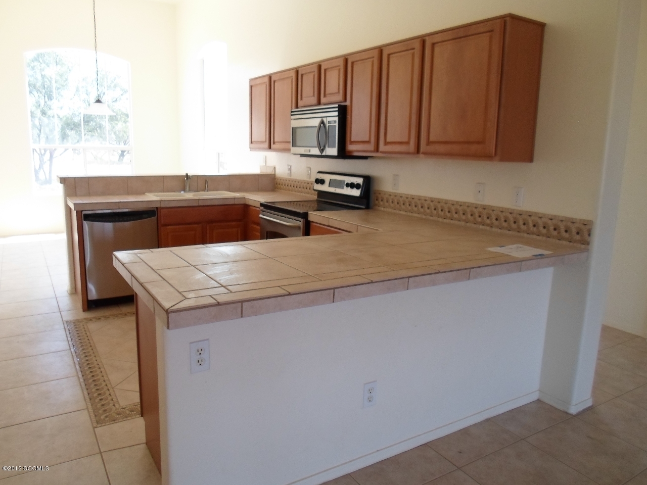 1834 Via Nevada Rio Rico, AZ 85648 - Photo 4 of 10 a kitchen with stainless steel appliances granite countertop a sink stove and microwave