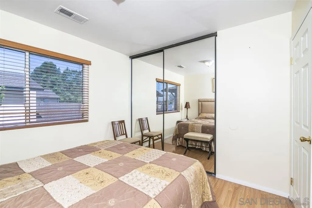 10321 Carefree Drive Santee, CA 92071 - Photo 14 of 22 a bedroom with a bed and a large window