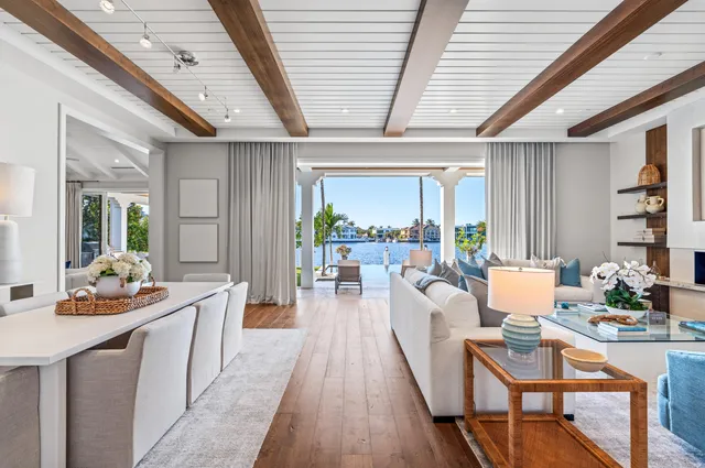 a living room with fireplace furniture and a large window