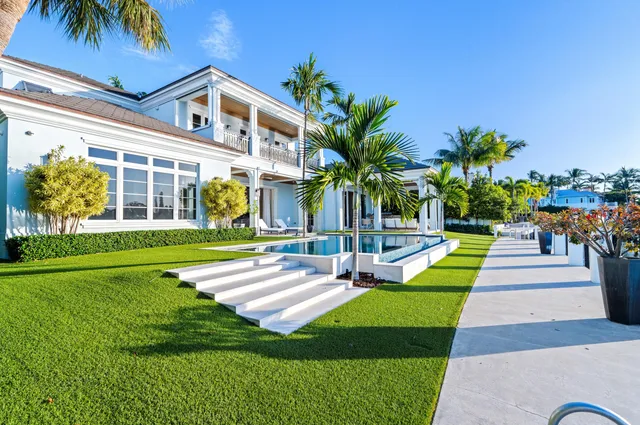 a view of a house with a swimming pool and a yard