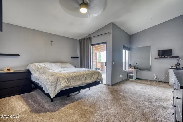 a bedroom with a bed and a chair