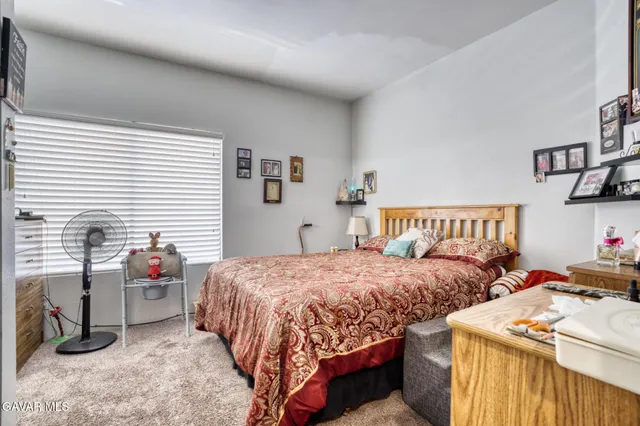 a bedroom with two beds and a window