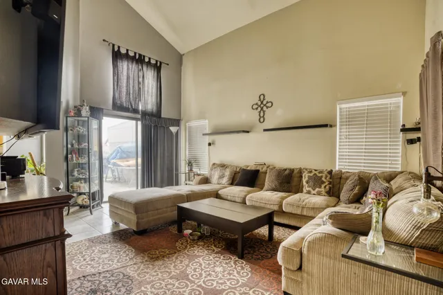 a living room with furniture wooden floor and a large window