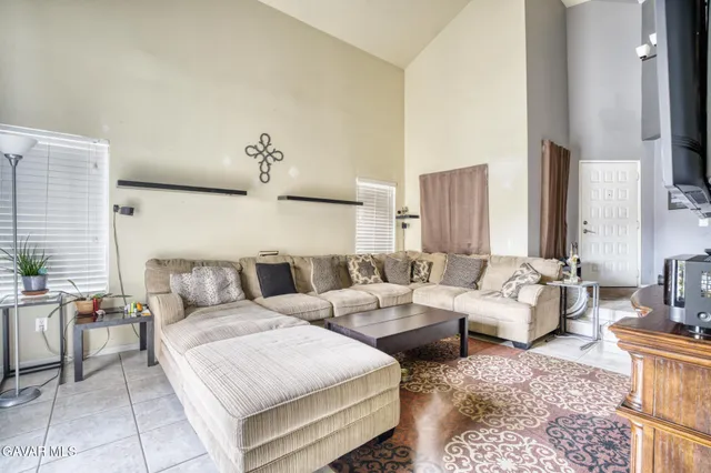 a living room with furniture and large windows