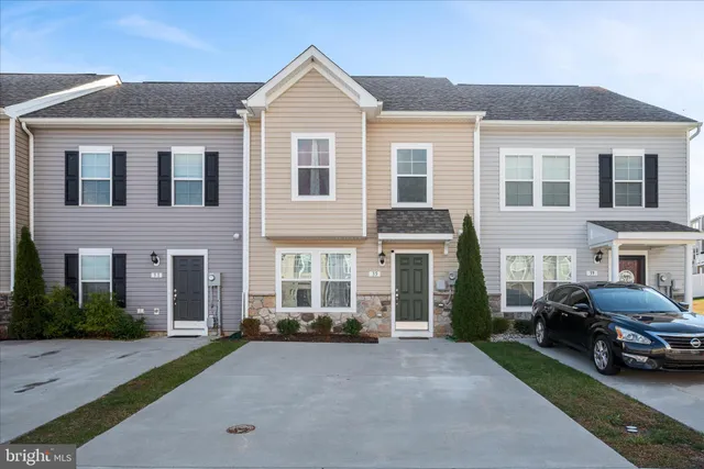 a view of a white house and a yard in front of it