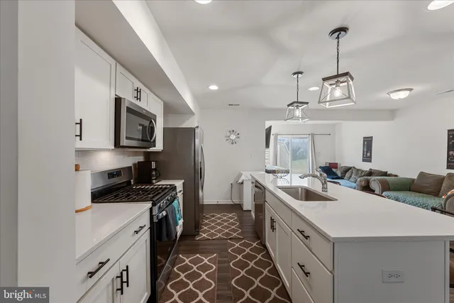 a kitchen with a sink stove and cabinets