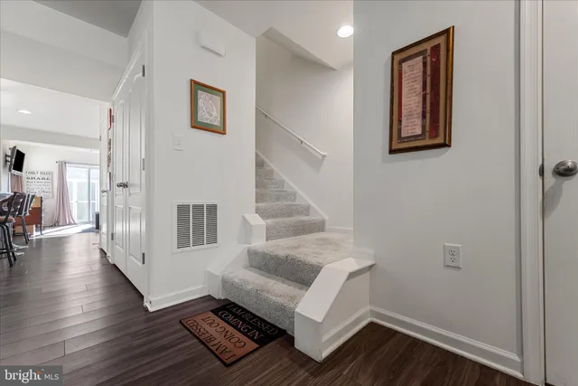 a view of entryway with wooden floor and stairs