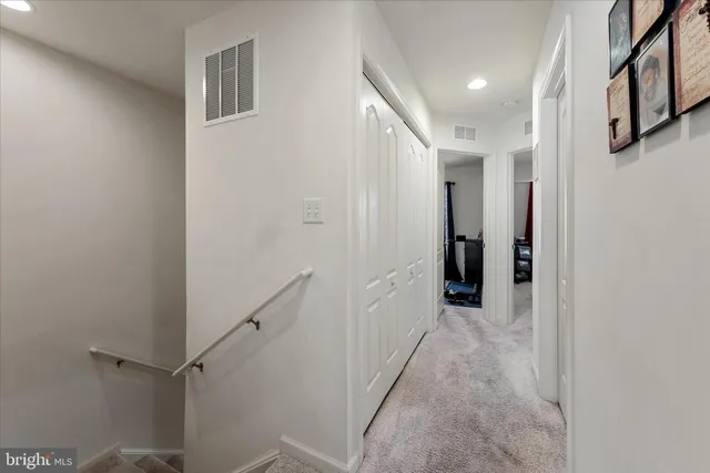 a view of a hallway with a white walls