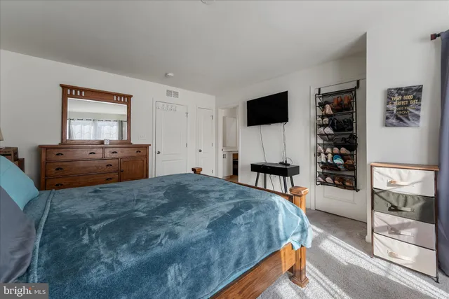 a bedroom with a bed and a television