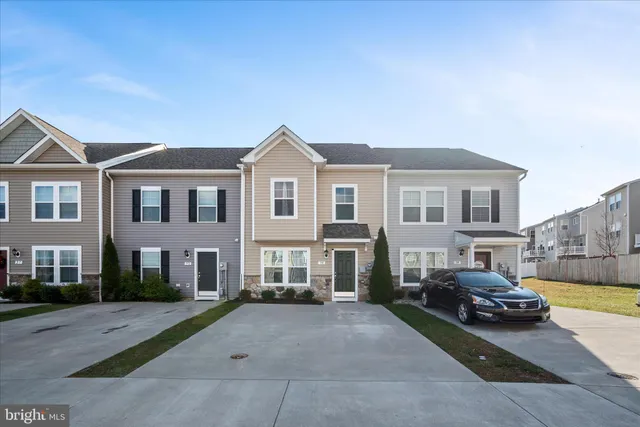 a view of a car parked in front of a brick house