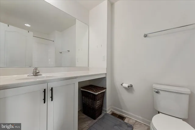 a bathroom with a sink toilet and vanity