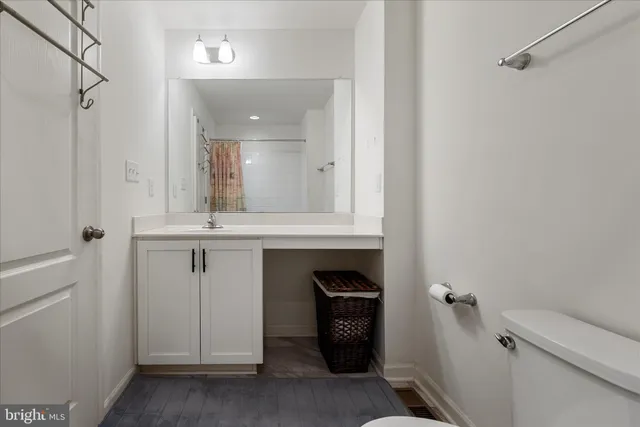 a bathroom with a sink a toilet and a mirror